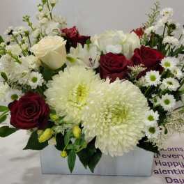 Red roses and white chrysanthemums in a rectangular vase