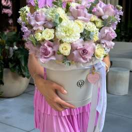 Lavender and cream bouquet in a round hatbox with ribbon