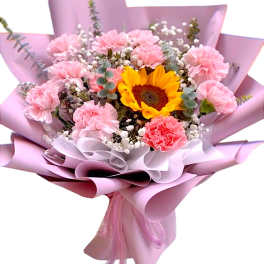 Pink carnation and sunflower bouquet wrapped in lavender paper