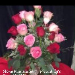 Bouquet of pink and red roses with greenery