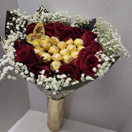 Bouquet of red roses with white baby's breath and gold chocolates