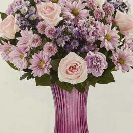 Pink and lavender bouquet in a ribbed magenta vase