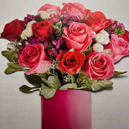 Bouquet of red and pink roses in a pink cylindrical box
