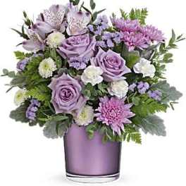 Lavender and pink bouquet in a purple glass vase