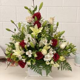 Red and white floral basket with lilies and roses