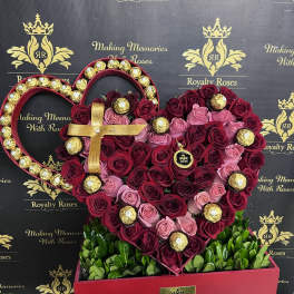 Heart-shaped rose arrangement with gold-wrapped chocolates in a red box