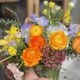 Bouquet of orange, yellow, and lavender flowers