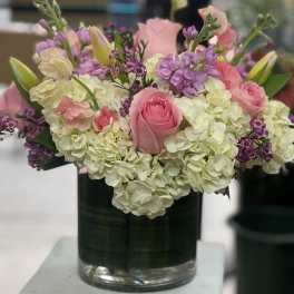 Pink roses and white hydrangeas in a glass vase