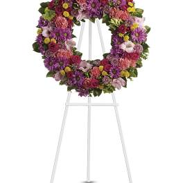 Colorful floral wreath on a white easel