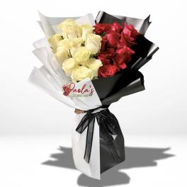 Bouquet of red and cream roses wrapped in black and white paper