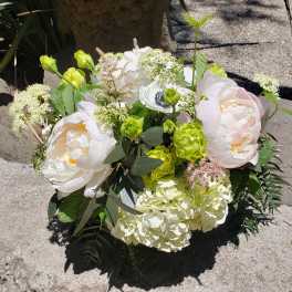 Bouquet of pale pink and white flowers with green accents