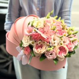 Pink rose bouquet in a round pink hatbox with a white ribbon