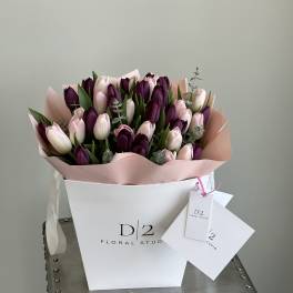 Bouquet of pink and deep purple tulips in a white box