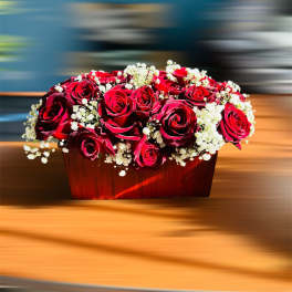 Red roses and white baby's breath in a wooden box