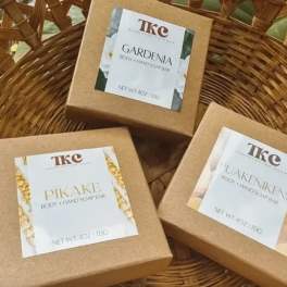Three boxed body and hand soap bars in a wicker basket