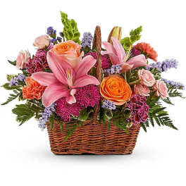 Basket arrangement with pink lilies, roses, and purple flowers