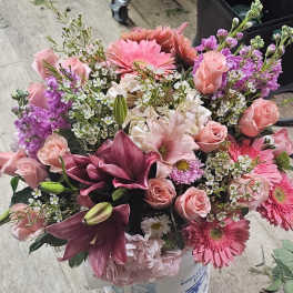 Bouquet of pink and purple flowers in a container