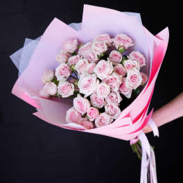 Bouquet of pale pink roses wrapped in pink paper