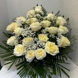 White rose bouquet with baby's breath and palm leaves