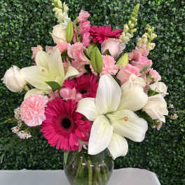 Pink and white mixed bouquet in a clear glass vase