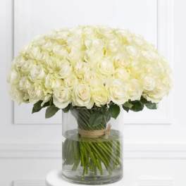 Large bouquet of white roses in a clear glass vase