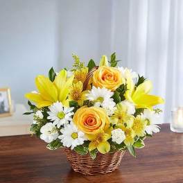 Yellow and white flower arrangement in a wicker basket