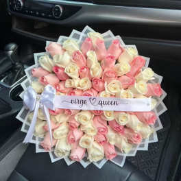Large bouquet of pink and white roses with a ribbon