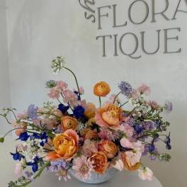Mixed pastel bouquet in a low white vase