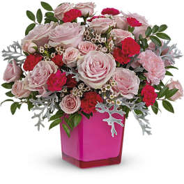 Pink and red rose bouquet in a bright pink vase