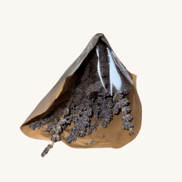Dried blue-purple flowers wrapped in brown paper and clear plastic