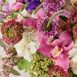 Bouquet of pink orchids, purple blooms, and white flowers