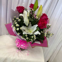Bouquet of pink roses and white lilies with small white daisies