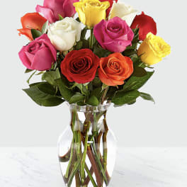 Bouquet of multicolored roses in a clear glass vase