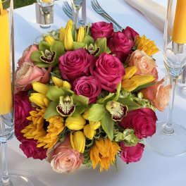 Bright mixed bouquet with pink roses, yellow tulips, and green orchids