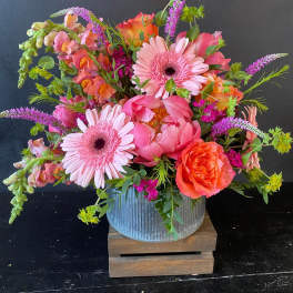 Bright pink and orange mixed bouquet in a ribbed metal container