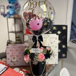 Birthday balloon arrangement with pink and black roses in a black box