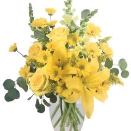 Yellow mixed bouquet in a clear glass vase
