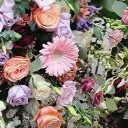 Mixed bouquet with pink, peach, and lavender flowers