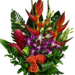 Tropical bouquet with orange roses, purple orchids, and red heliconia in a vase