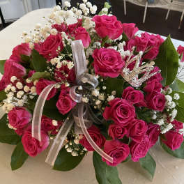 Bouquet of hot pink roses with baby's breath and a ribbon bow
