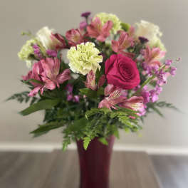 Pink and white mixed bouquet in a burgundy vase