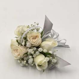 Small bouquet of cream roses and white filler flowers with silver ribbon