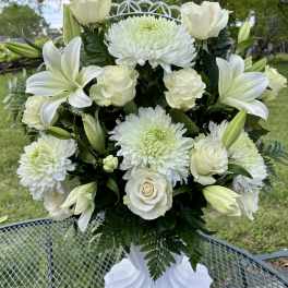 White roses, lilies, and chrysanthemums in a white vase
