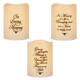 Three memorial candles with remembrance text