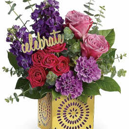 Bouquet of pink and purple flowers in a yellow decorative box