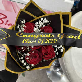 Bouquet of red roses with baby's breath and a graduation ribbon