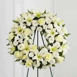 White floral wreath on a black easel