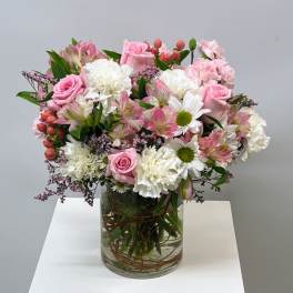 Pink and white mixed bouquet in a clear glass vase