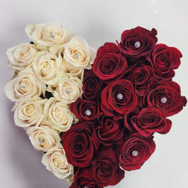 Heart-shaped arrangement of cream and red roses with jeweled centers