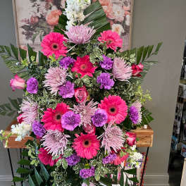 Large standing floral spray with pink, purple, and white flowers
